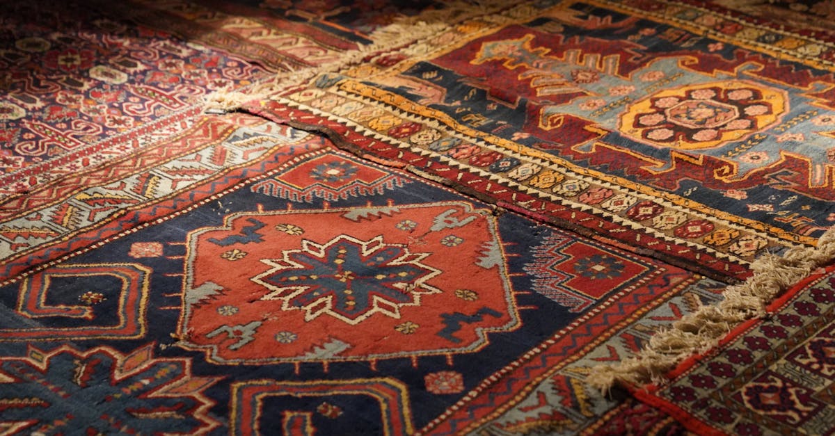 A detailed view of colorful Persian carpets with intricate geometric and floral patterns, highlighting vintage design.